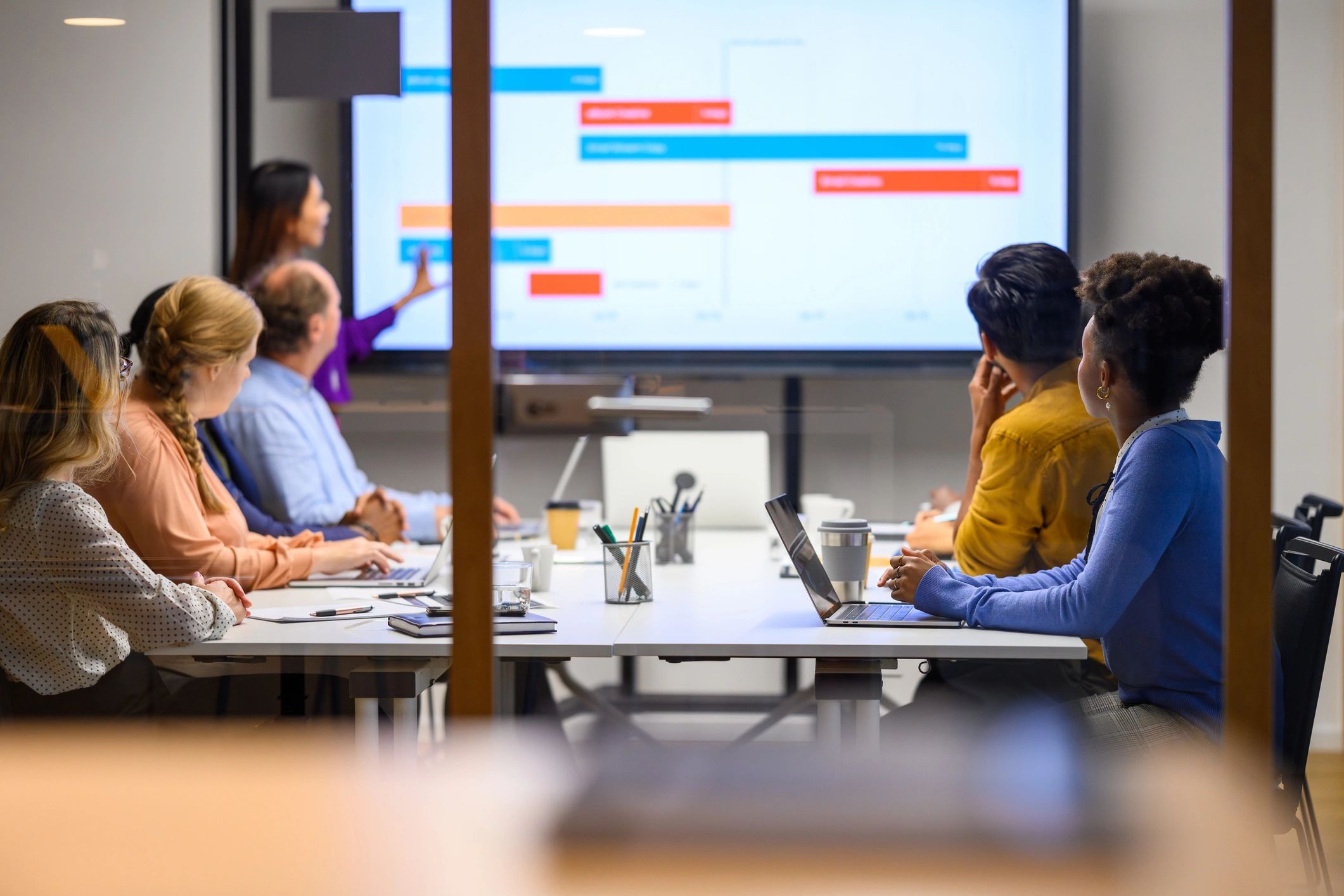 Business professional presenting in a logistics planning meeting